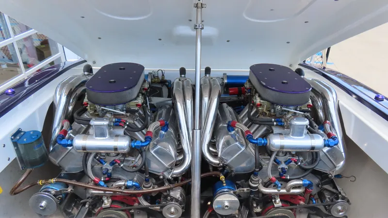 Slide: The Image of Twin engines in a 1998 Hustler 388 SLINGSHOT boat, showcasing intricate mechanical details. - 14