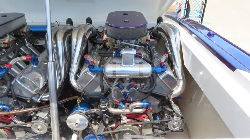 Slide: The Image of High-performance engine of a 1998 Hustler 388 SLINGSHOT boat, showcasing intricate components. - 16