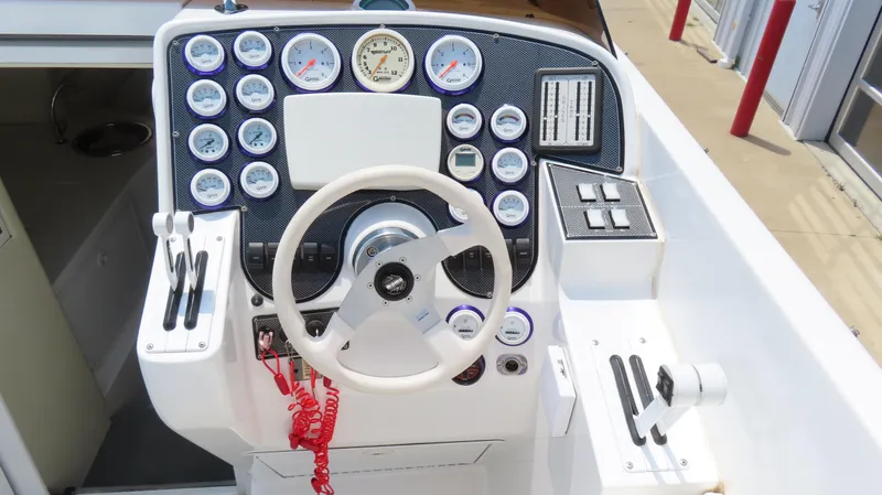 Slide: The Image of Control panel of a 1998 Hustler 388 SLINGSHOT boat with gauges and steering wheel. - 7
