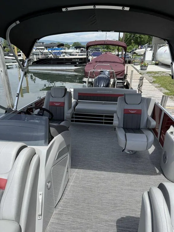Slide: The Image of 2024 Bennington 24 LXSSB pontoon boat interior at a marina dock. - 10