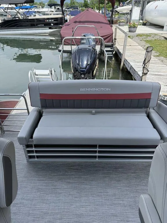 Slide: The Image of 2024 Bennington 24 LXSSB pontoon boat with gray seating at a dock. - 12