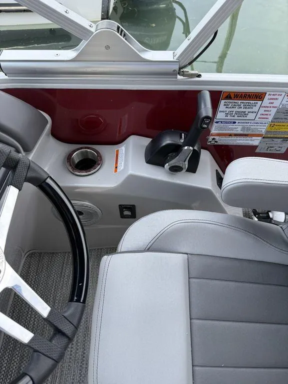 Slide: The Image of 2024 Bennington 24 LXSSB boat interior with steering wheel and control panel. - 15