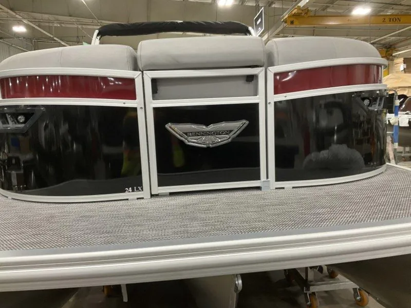 Slide: The Image of 2024 Bennington 24 LXSSB pontoon boat rear view in a warehouse setting. - 16