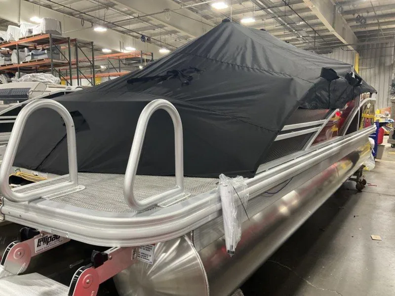 Slide: The Image of 2024 Bennington 24 LXSSB pontoon boat covered in a warehouse setting. - 21