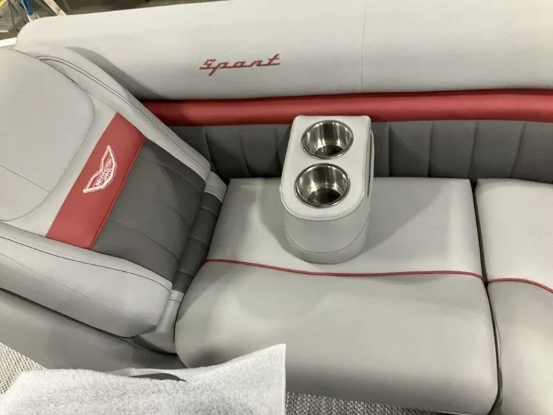 Slide: The Image of 2024 Bennington 24 LXSSB boat interior with gray and red seating, featuring dual cup holders. - 24