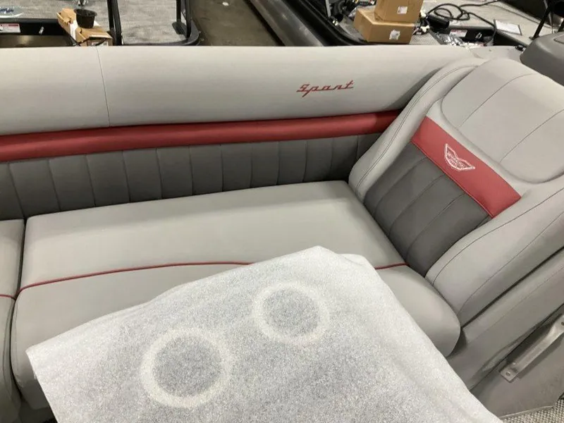 Slide: The Image of 2024 Bennington 24 LXSSB boat interior with gray and red seating, showcasing luxury design. - 25