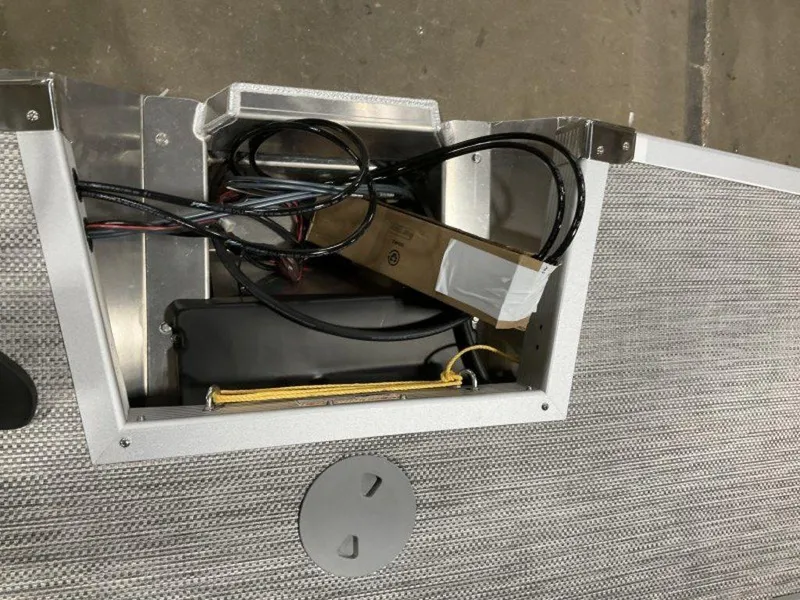 Slide: The Image of 2024 Bennington 24 LXSSB boat wiring compartment with cables and components. - 26