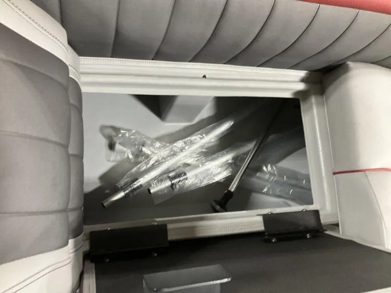 Slide: The Image of Storage compartment in 2024 Bennington 24 LXSSB boat with wrapped accessories inside. - 28