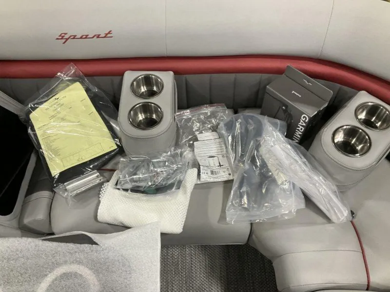 Slide: The Image of 2024 Bennington 24 LXSSB boat interior with accessories and Garmin equipment on seats. - 29