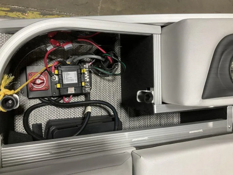 Slide: The Image of 2024 Bennington 24 LXSSB boat battery compartment with wiring and components. - 30