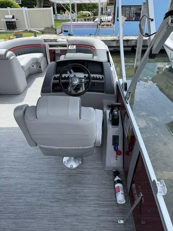Slide: The Image of 2024 Bennington 24 LXSSB boat interior with steering wheel and seating. - 7