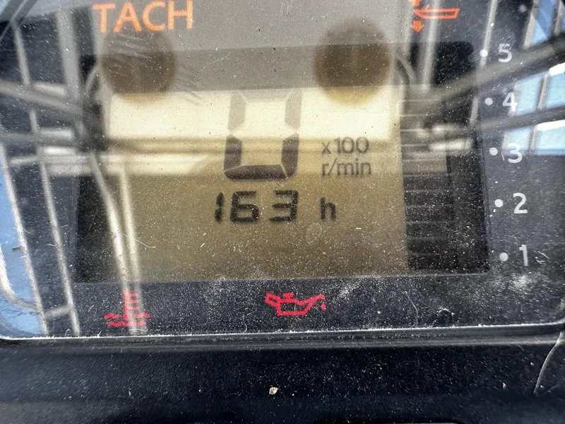 Slide: The Image of Close-up of a May-Craft 2000CC 2011 tachometer displaying 163 hours. - 12
