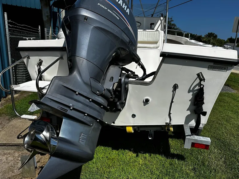 Slide: The Image of 2011 May-Craft 2000CC boat with Yamaha outboard motor, parked on grass. - 15