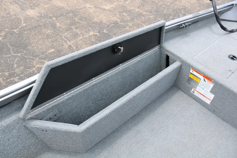 Slide: The Image of 2019 Alumacraft Prowler 175 boat storage compartment with open lid, showcasing interior space. - 11