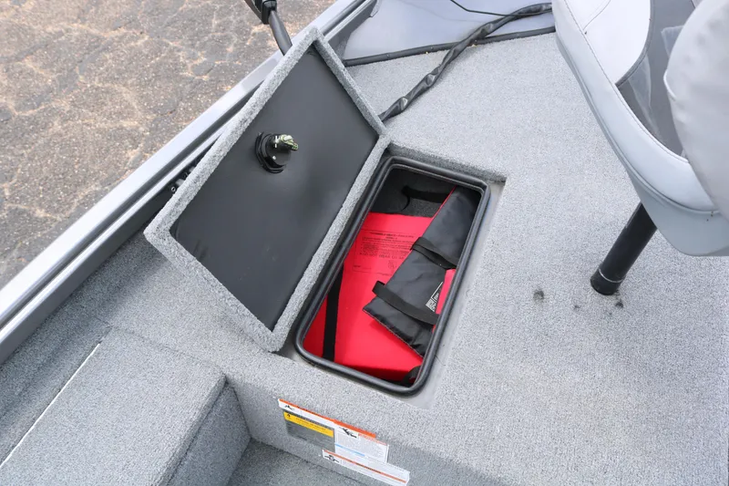 Slide: The Image of Open storage compartment in 2019 Alumacraft Prowler 175 boat with red life jacket. - 13