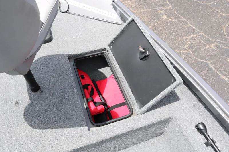 Slide: The Image of 2019 Alumacraft Prowler 175 boat storage compartment with red life jacket. - 14