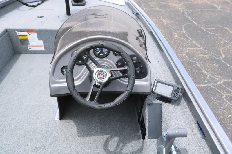 Slide: The Image of 2019 Alumacraft Prowler 175 boat dashboard with steering wheel and navigation system. - 16