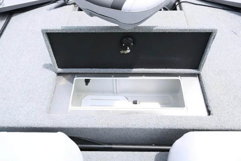 Slide: The Image of 2019 Alumacraft Prowler 175 boat storage compartment with open lid and gray interior. - 19
