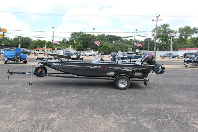 Slide: The Image of 2019 Alumacraft Prowler 175 boat on trailer in parking lot, side view. - 4