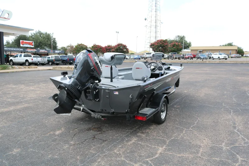 Slide: The Image of 2019 Alumacraft Prowler 175 boat with Evinrude motor in a parking lot. - 6