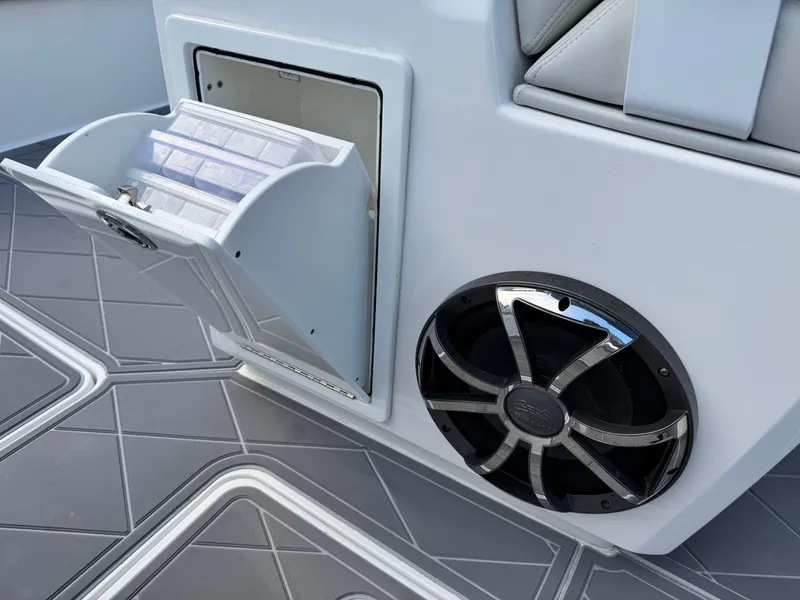 Slide: The Image of Open storage compartment and speaker on 2022 Invincible 40 Catamaran boat. - 23