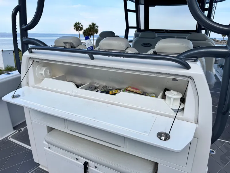 Slide: The Image of Open storage compartment on 2022 Invincible 40 Catamaran, featuring fishing gear and accessories. - 25