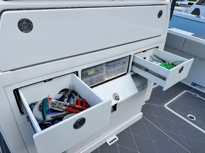 Slide: The Image of Fishing gear storage on 2022 Invincible 40 Catamaran, featuring organized drawers and tackle boxes. - 26