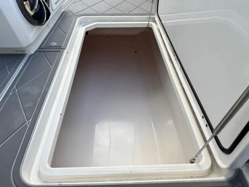 Slide: The Image of Open storage compartment on 2022 Invincible 40 Catamaran boat, showcasing interior space. - 28