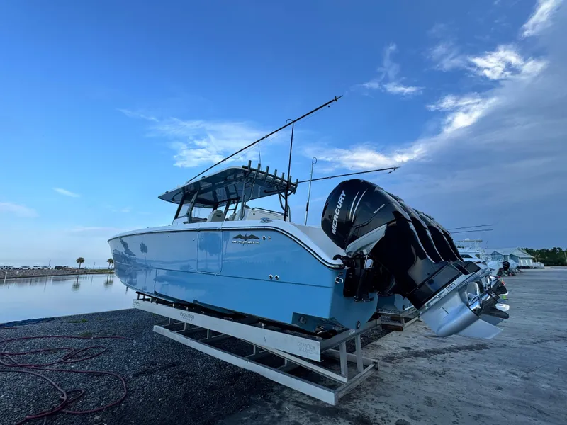 Slide: The Image of 2022 Invincible 40 Catamaran with Mercury engines on a dock, under a clear blue sky. - 3