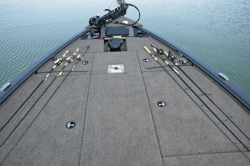 Slide: The Image of Manufacturer Provided Image: 2025 Lund 1875 Pro-V Bass XS boat deck with fishing rods on calm water. - 8