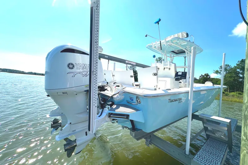 Slide: The Image of 2021 Tidewater 2700 Carolina Bay boat on lift, featuring Yamaha outboard motor. - 1