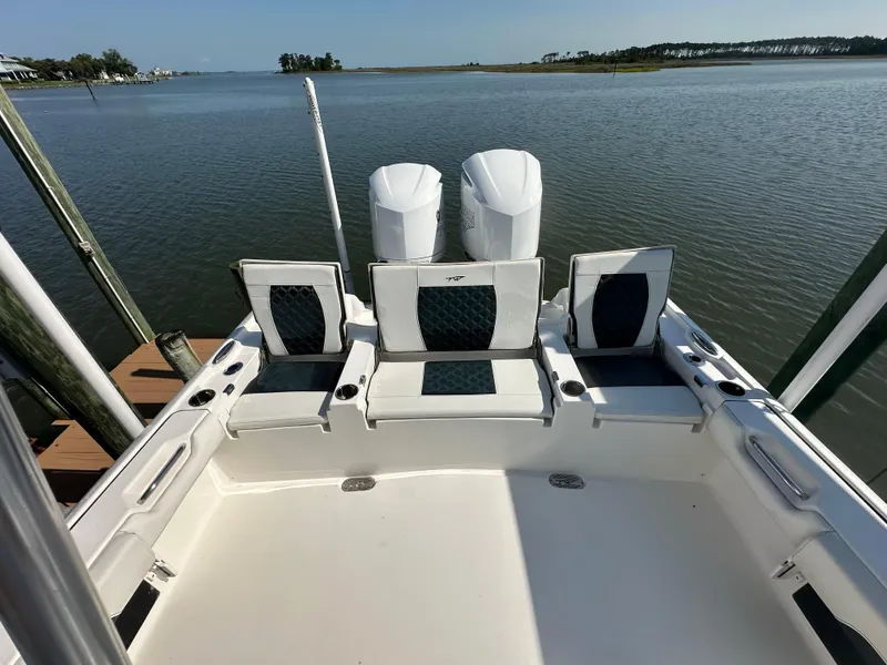 Slide: The Image of 2021 Tidewater 2700 Carolina Bay boat with dual engines on calm water. - 12