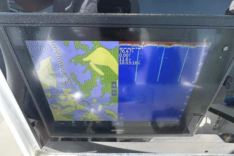 Slide: The Image of Garmin marine display on 2021 Tidewater 2700 Carolina Bay, showing navigation and sonar data. - 13