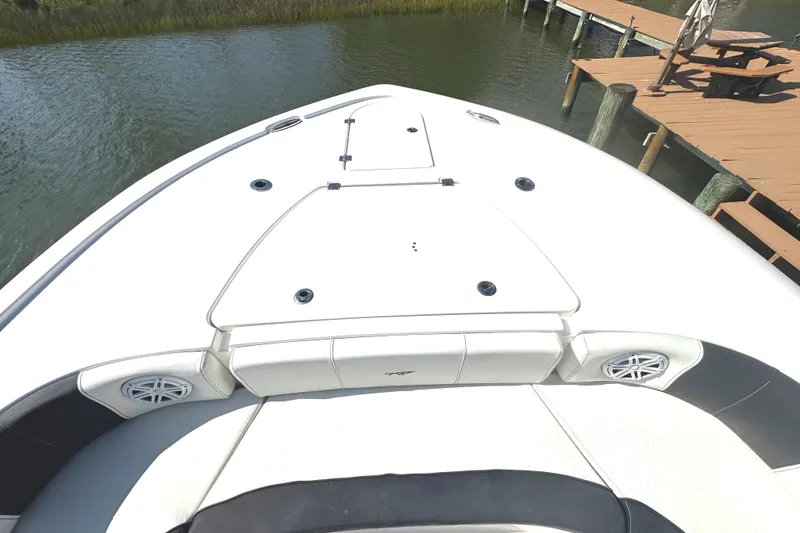 Slide: The Image of 2021 Tidewater 2700 Carolina Bay boat bow near dock, featuring sleek design and speakers. - 19