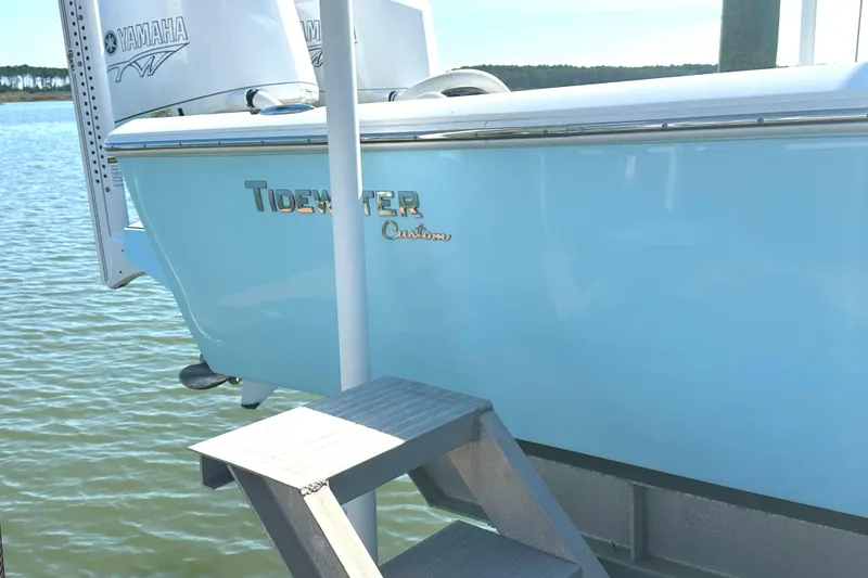 Slide: The Image of 2021 Tidewater 2700 Carolina Bay boat docked, featuring Yamaha engine. - 2