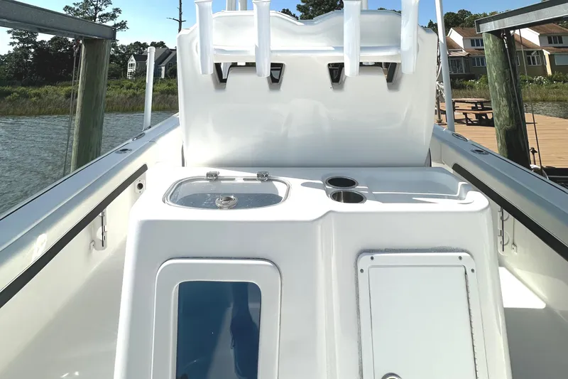 Slide: The Image of 2021 Tidewater 2700 Carolina Bay boat interior with rod holders and storage compartments. - 3
