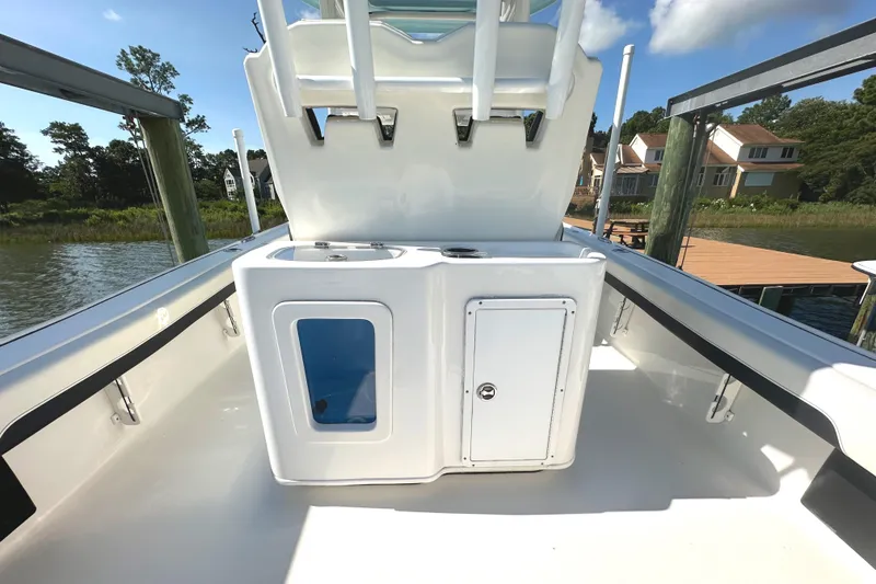 Slide: The Image of 2021 Tidewater 2700 Carolina Bay boat interior with storage compartments, dockside view. - 4