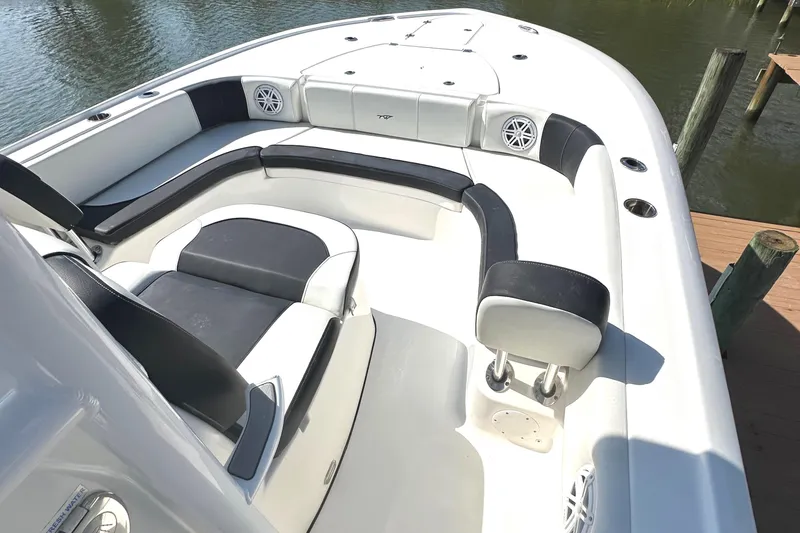 Slide: The Image of 2021 Tidewater 2700 Carolina Bay boat interior with cushioned seating and speakers. - 8