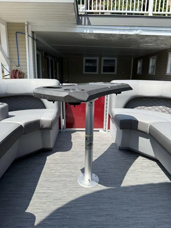 Slide: The Image of 2022 Bennington 23 LSBA boat interior with gray seating and central table. - 13