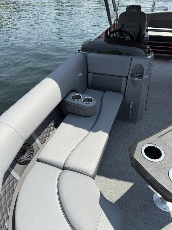 Slide: The Image of Luxurious seating on 2022 Bennington 23 LSBA pontoon boat with cup holders and steering console. - 14