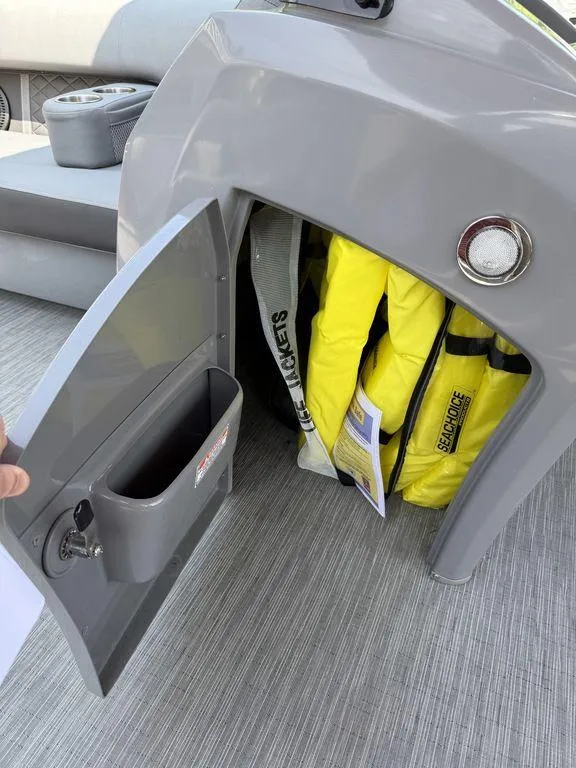 Slide: The Image of Open storage compartment on 2022 Bennington 23 LSBA boat with life jackets inside. - 17
