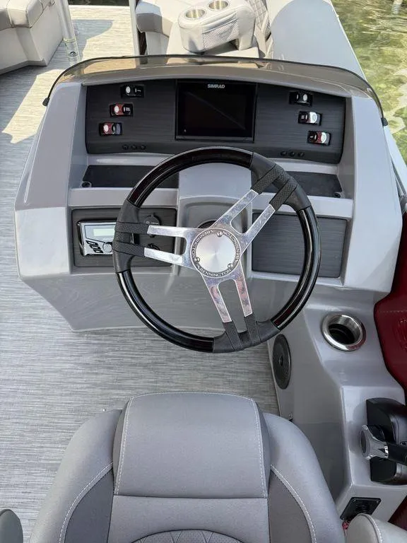 Slide: The Image of Steering console of 2022 Bennington 23 LSBA boat with modern controls and seating. - 2
