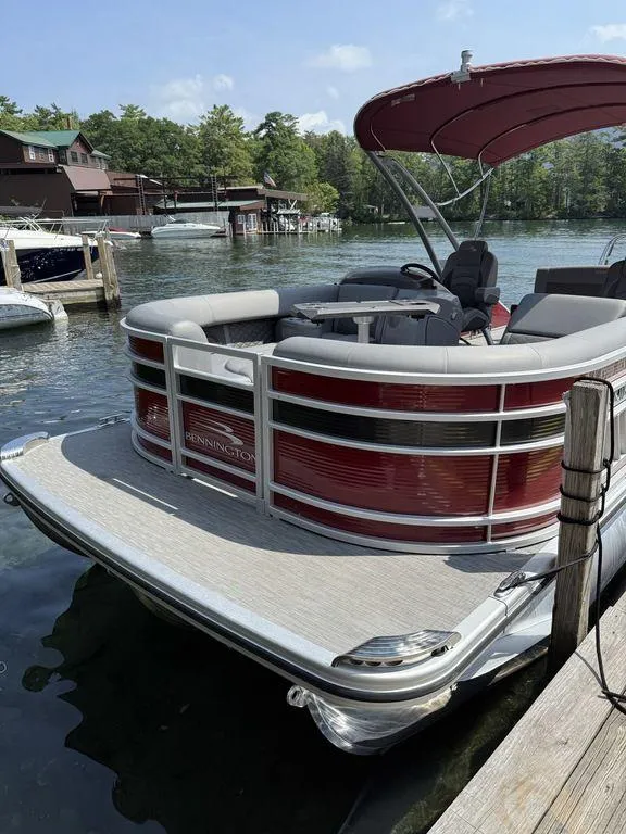Slide: The Image of 2022 Bennington 23 LSBA pontoon boat docked on a sunny day. - 22