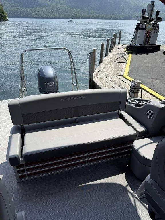 Slide: The Image of 2022 Bennington 23 LSBA pontoon boat at dock, featuring comfortable seating and scenic lake view. - 5