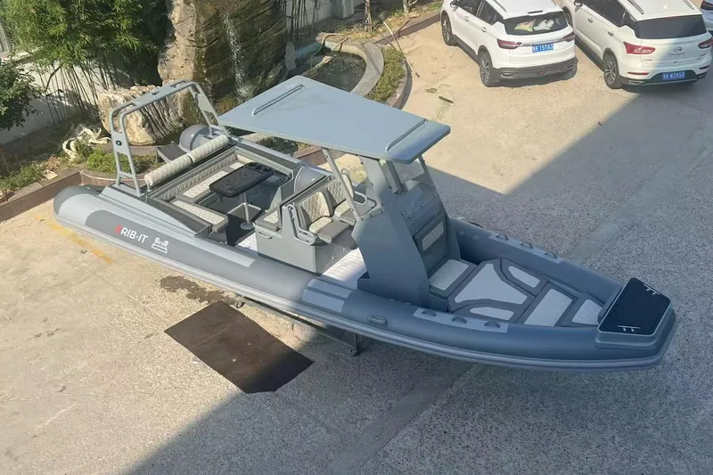 Slide: The Image of 2025 RIB-IT Ultra Light 26 inflatable boat in a parking area, featuring sleek design. - 2