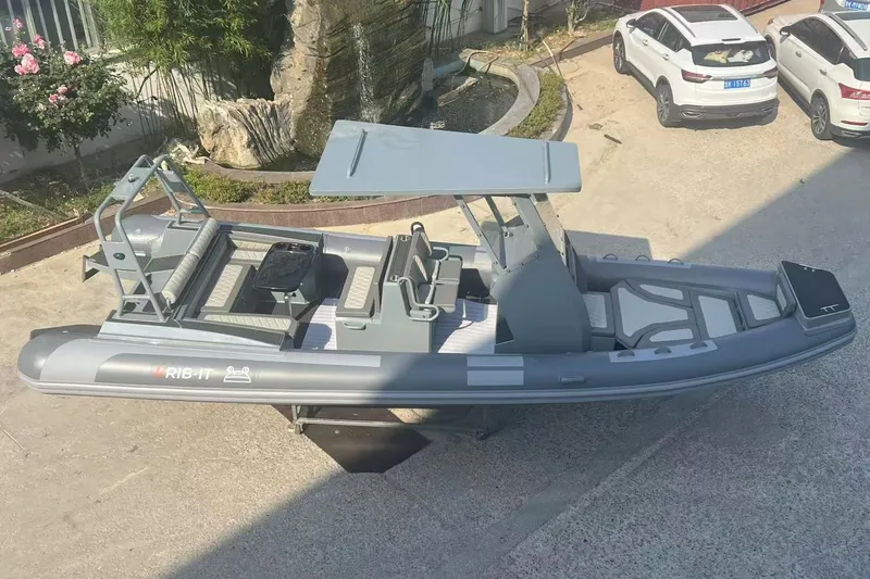Slide: The Image of 2025 RIB-IT Ultra Light 26 inflatable boat with canopy, parked outdoors. - 3