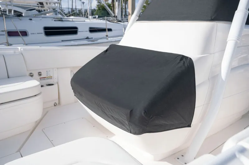 Slide: The Image of 2015 Intrepid 327 CC Infused boat interior with black seat cover. - 12