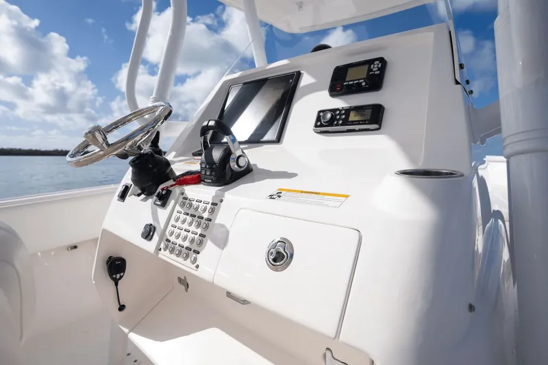 Slide: The Image of 2015 Intrepid 327 CC INFUSED boat console with steering wheel and navigation controls. - 18