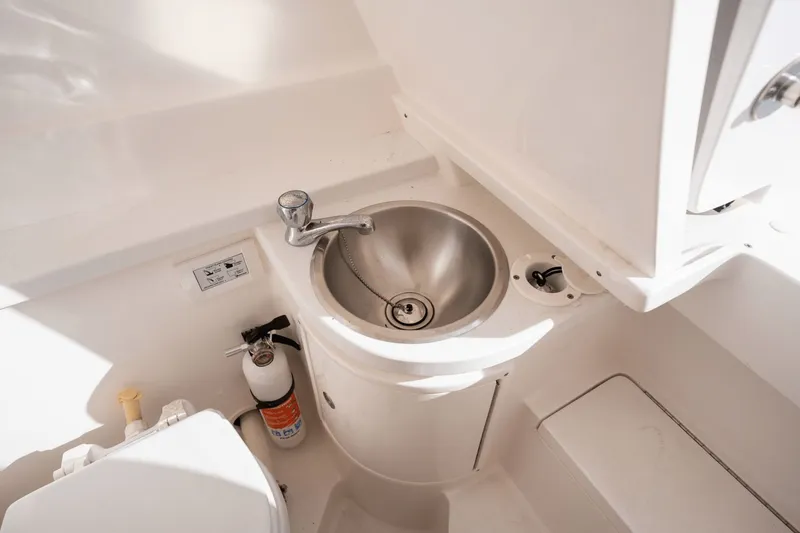 Slide: The Image of 2015 Intrepid 327 CC INFUSED boat interior with sink and fire extinguisher. - 21