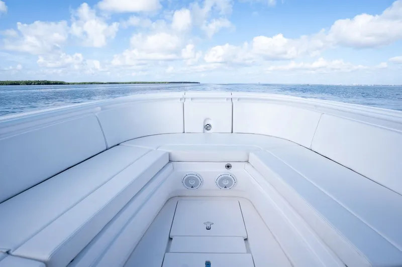 Slide: The Image of 2015 Intrepid 327 CC INFUSED boat interior with ocean view and blue sky. - 23